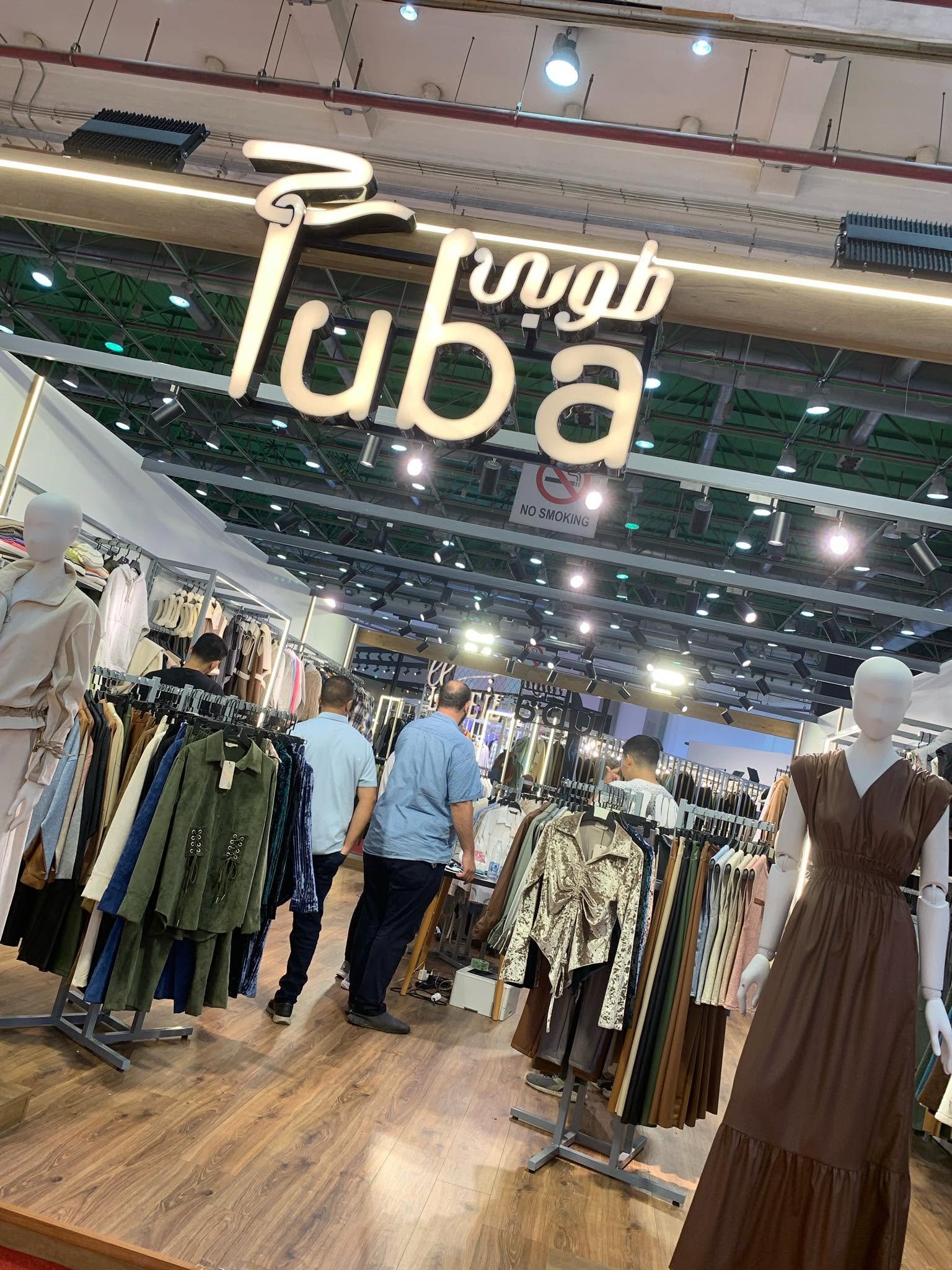 Inside the Tuba Fashion boutique, rails of dresses and separates